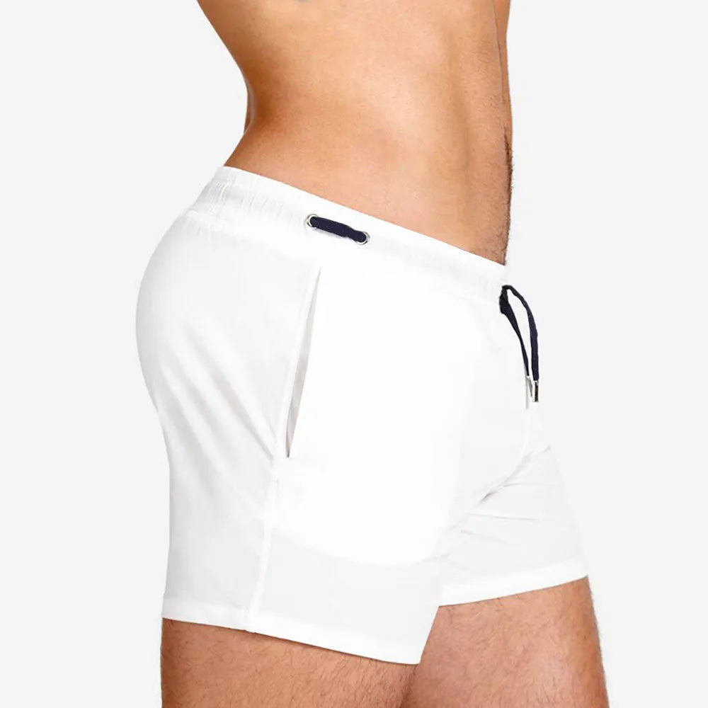 Mesh lining polyester sports shorts in solid colours for swimming and fitness.