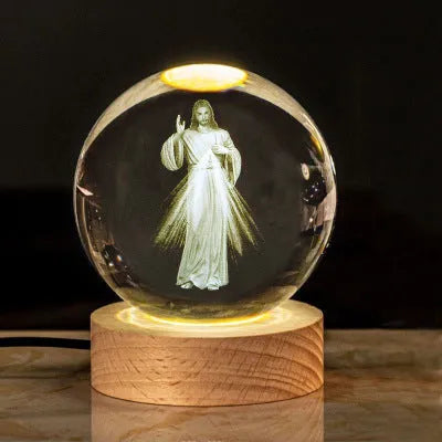White crystal ball with cross and religious symbols on wooden LED base desk ornament