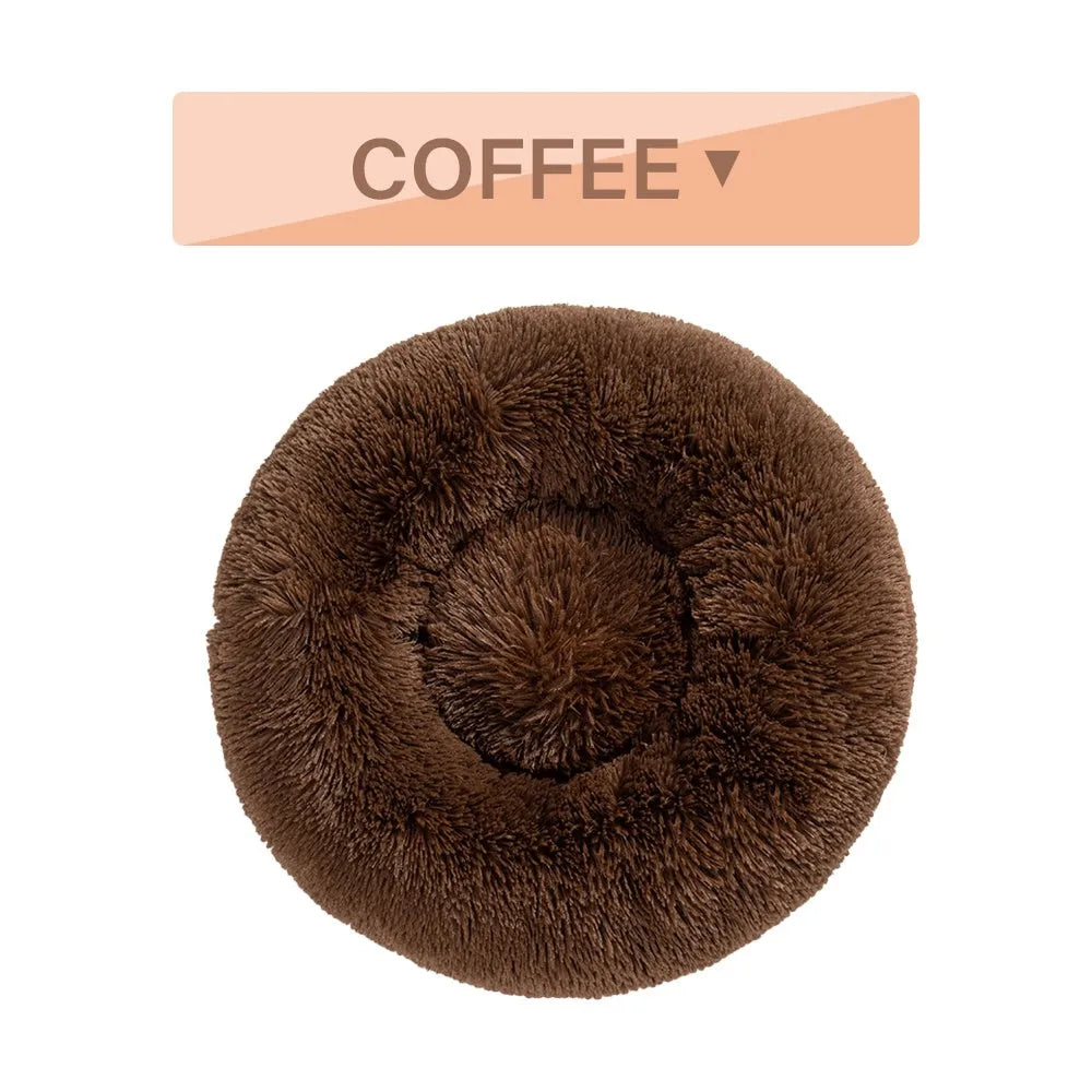 Fluffy donut-shaped pet bed in long plush fabric, shown in a light grey colour.