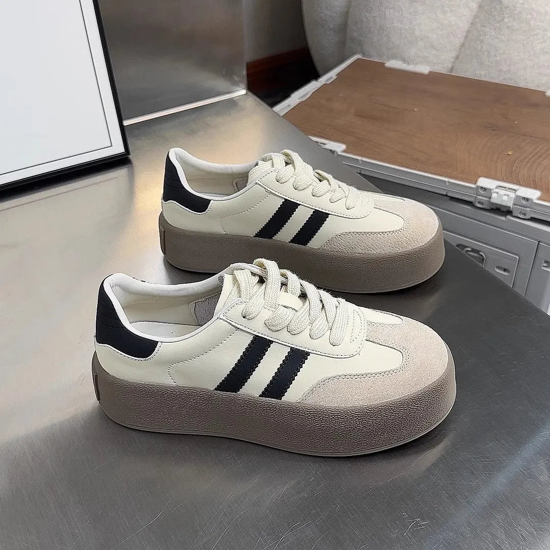 Women's beige distressed leather vintage lace-up sneakers with round toe and rubber sole on a white background.
