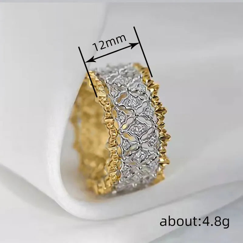 Geometric gold two-tone zircon ring on a copper band, showing round detail.
