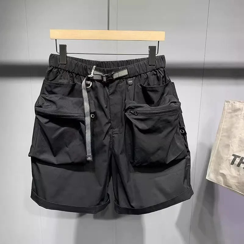 Man wearing loose fit black workwear shorts with pockets, showing above-the-knee length and straight leg style.