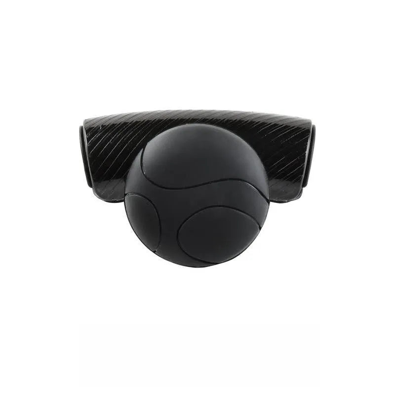 Close-up of black silicone steering wheel assist ball with metal bearing mechanism attached to a car steering wheel rim