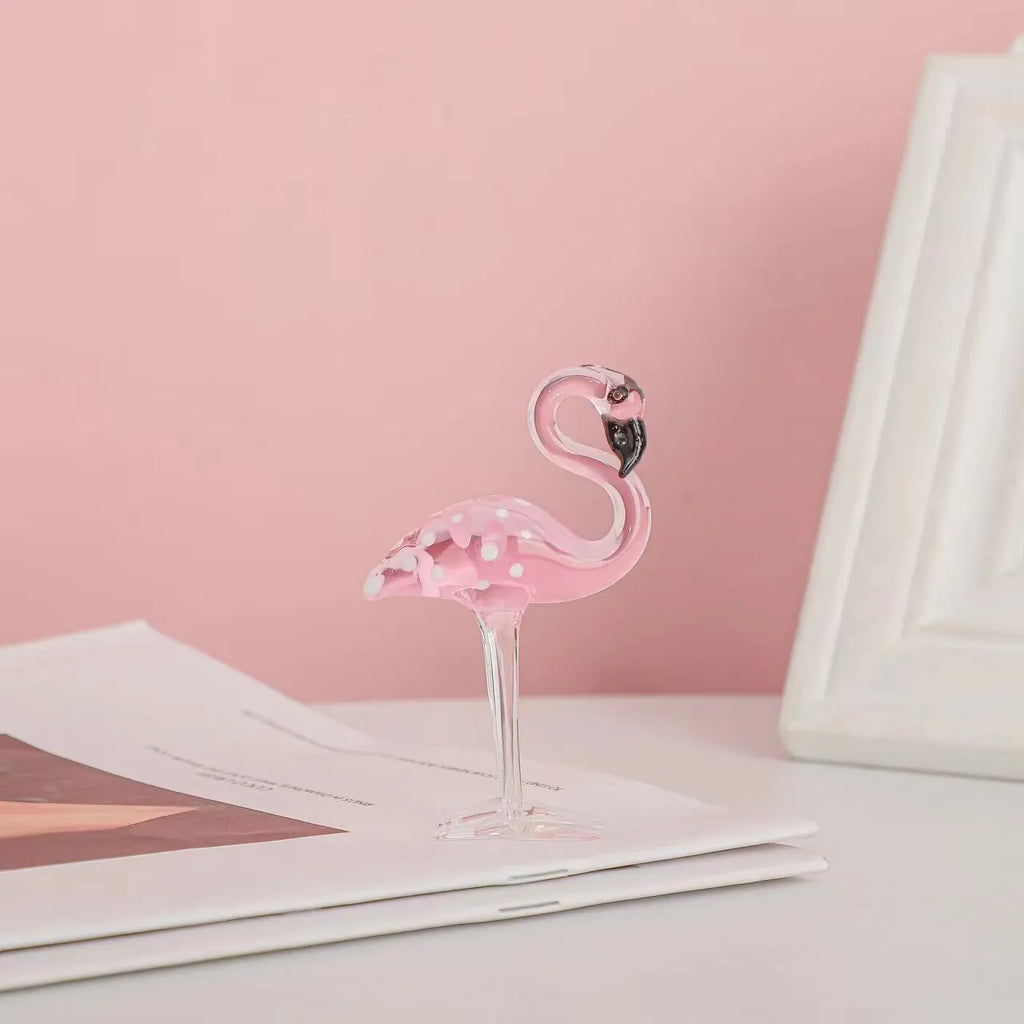 Pink crystal flamingo decorative ornament on table, available in separate or parallel styles.