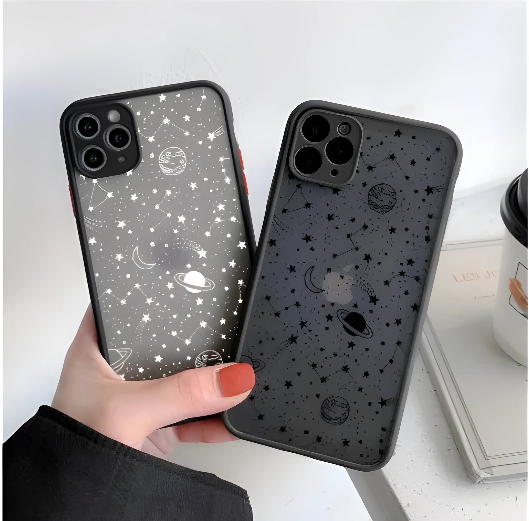 Black anti-blue-light soft-touch iPhone case for multiple models on a table.