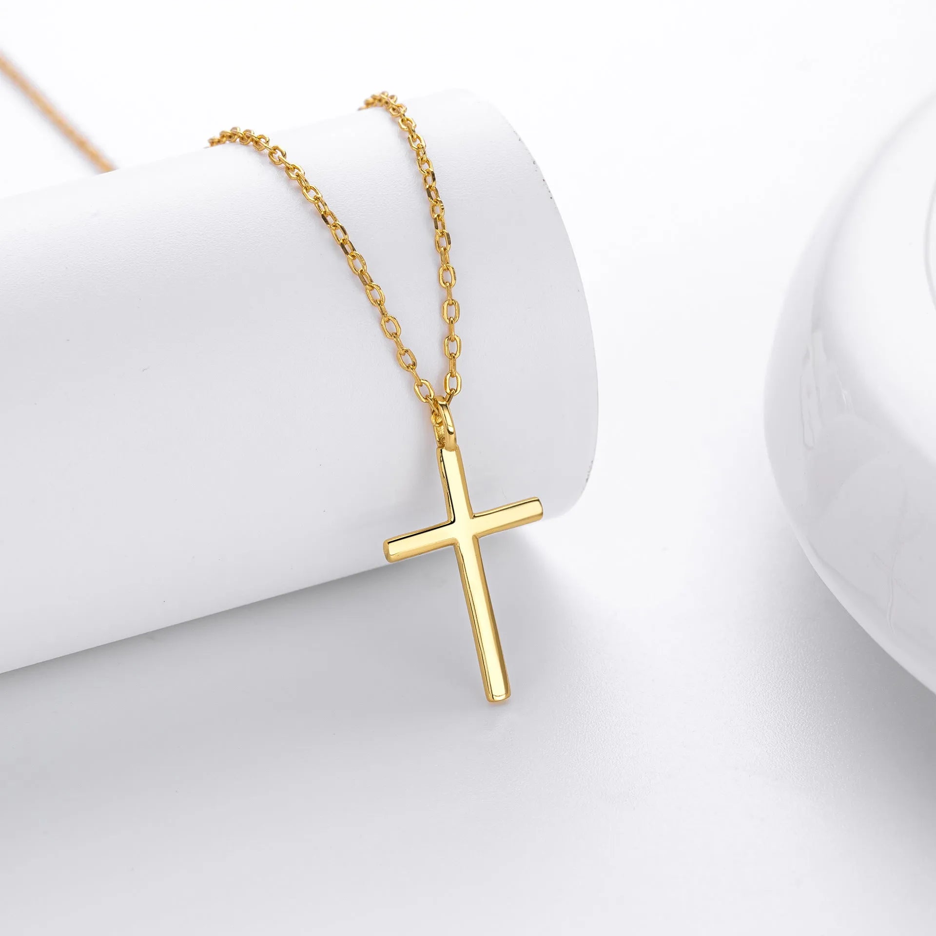 S925 sterling silver necklace showing simple glossy cross pendant on O-shaped chain in gold plating