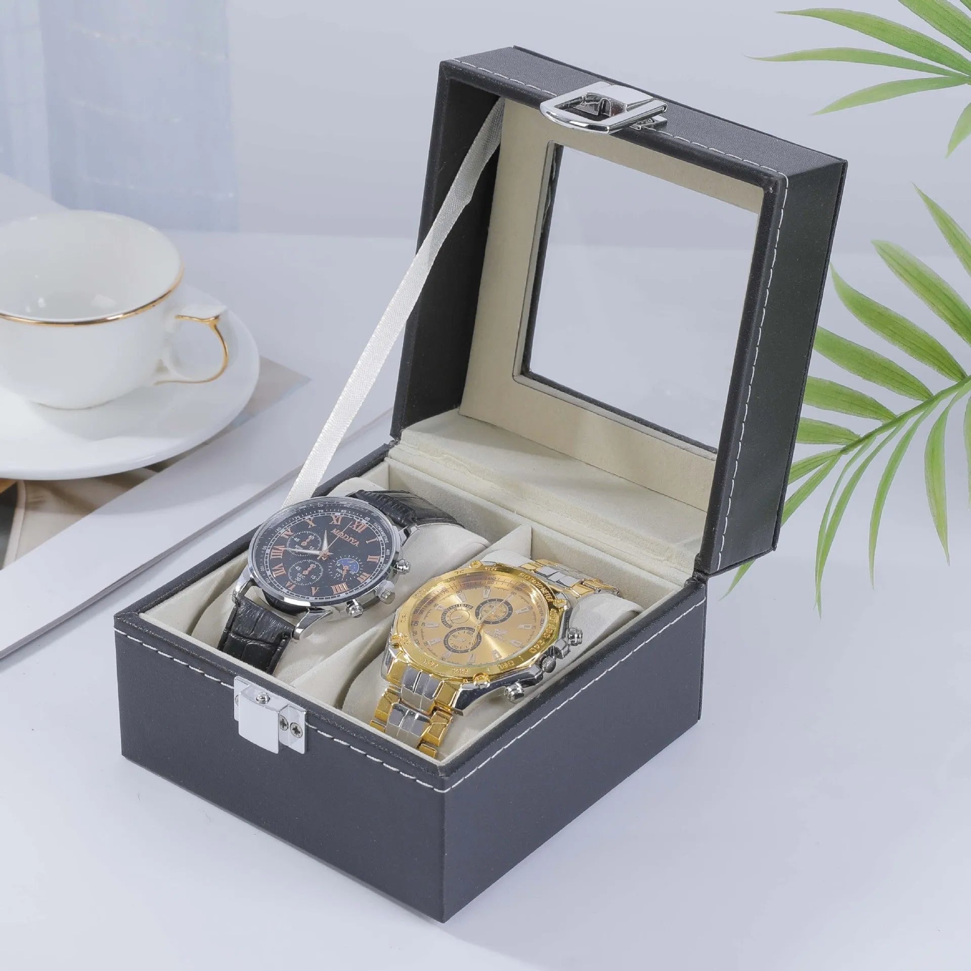 Grey leather watch storage box with clear lid showing watch compartments