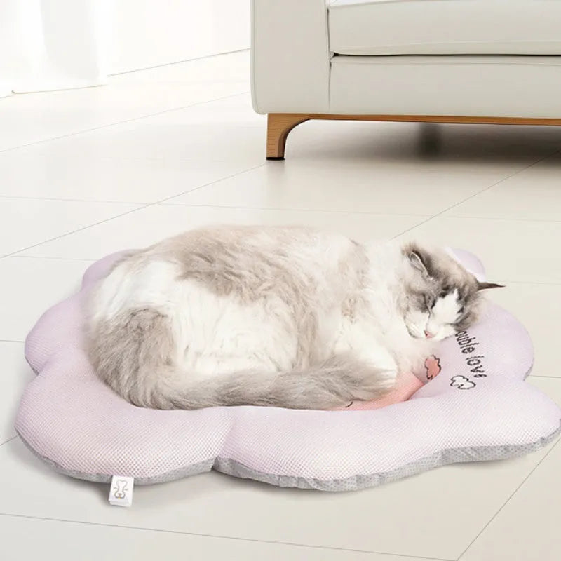 Green pet cooling mat for a medium-sized dog lying on a floor.