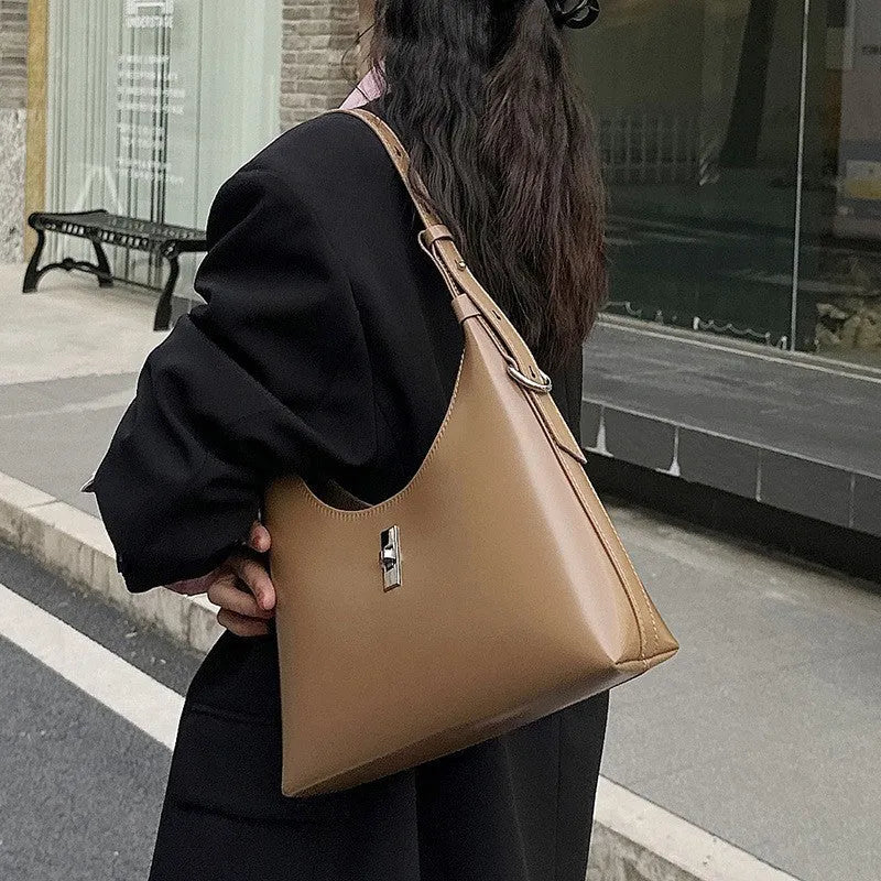 Genuine leather dumpling-shaped crossbody shoulder bag in apricot colour with a front sandwich pocket.