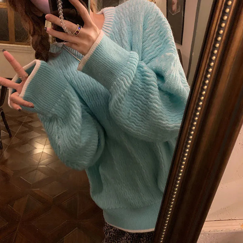 Women's lake blue loose fit pullover sweater on a hanger, front view.