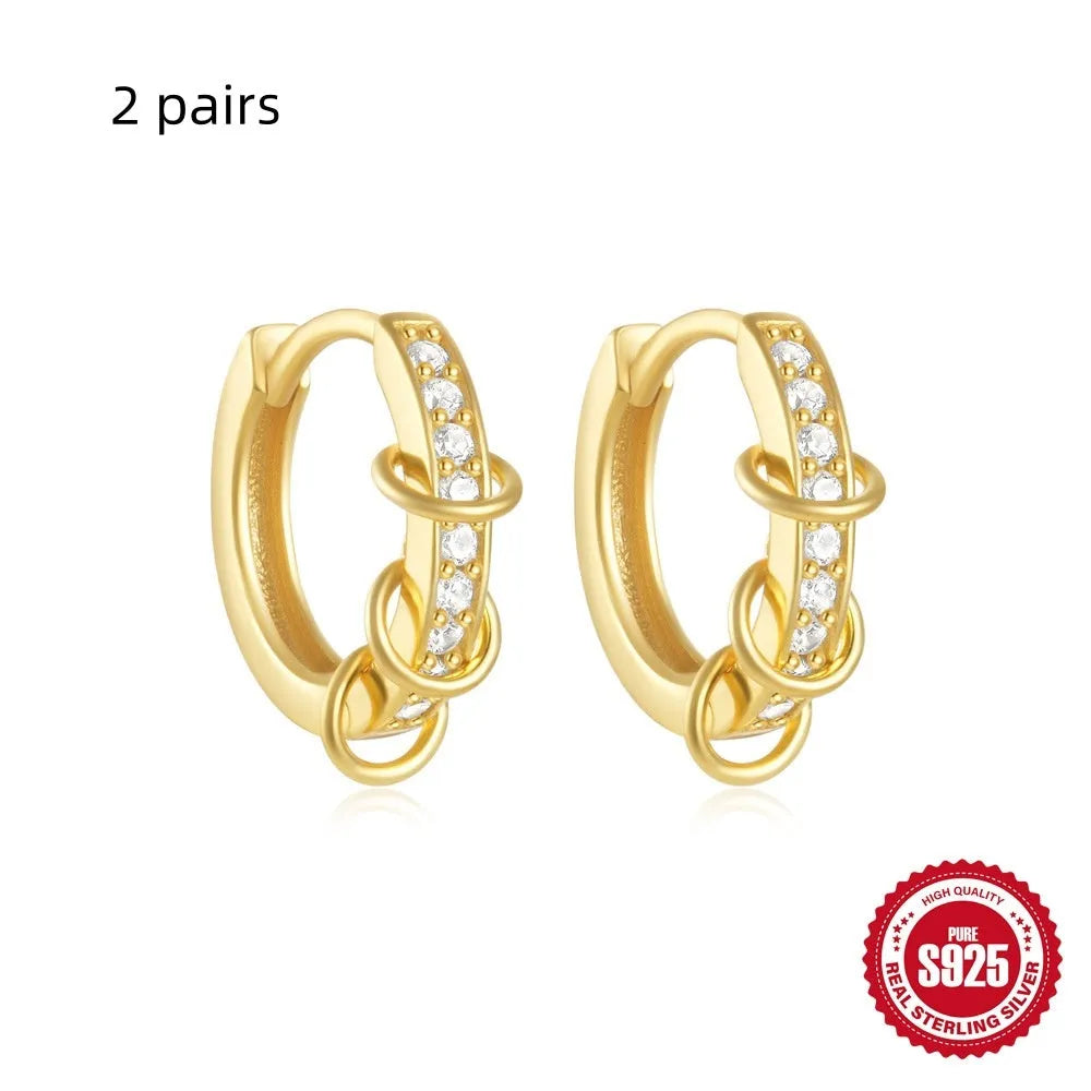 Sterling silver geometric stud earrings with small round design elements in gold or silver finish