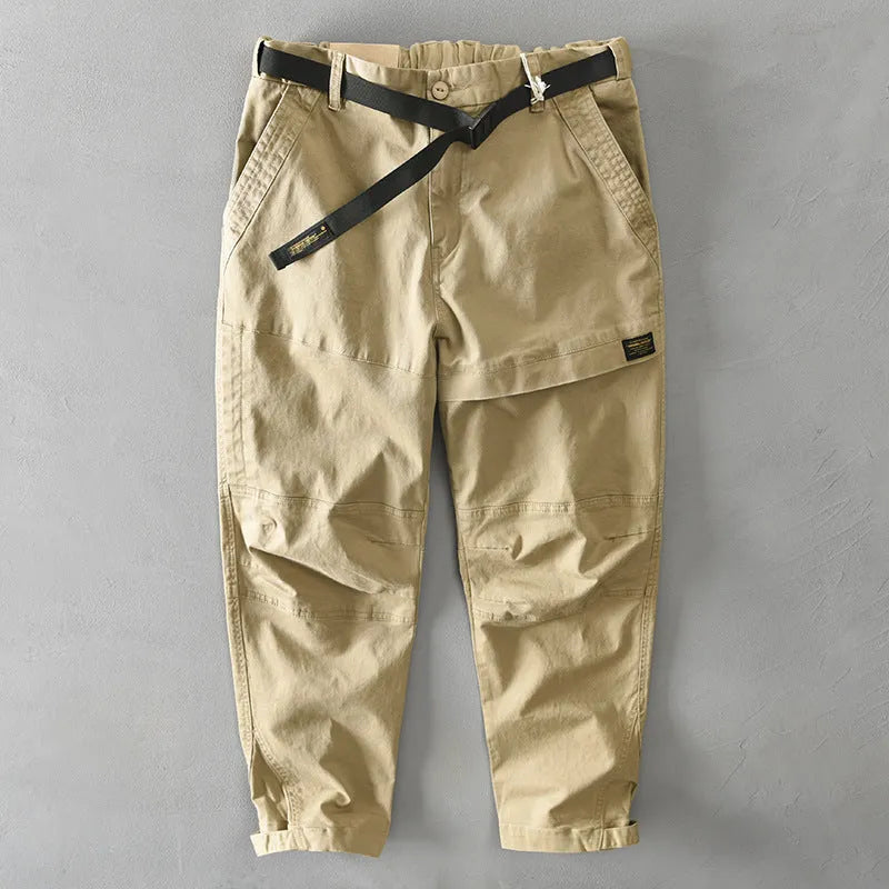 Men's khaki coloured loose-fit casual overalls with an elastic waistband on a hanger.