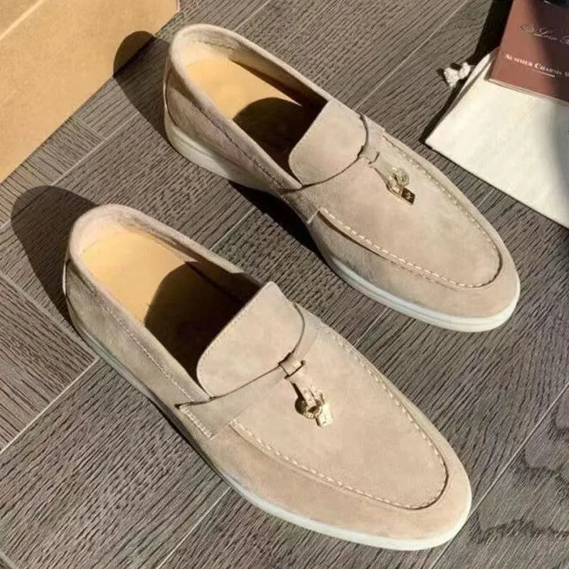 Unisex high-top slip-on loafers with a round toe cap and rubber sole on a neutral background.