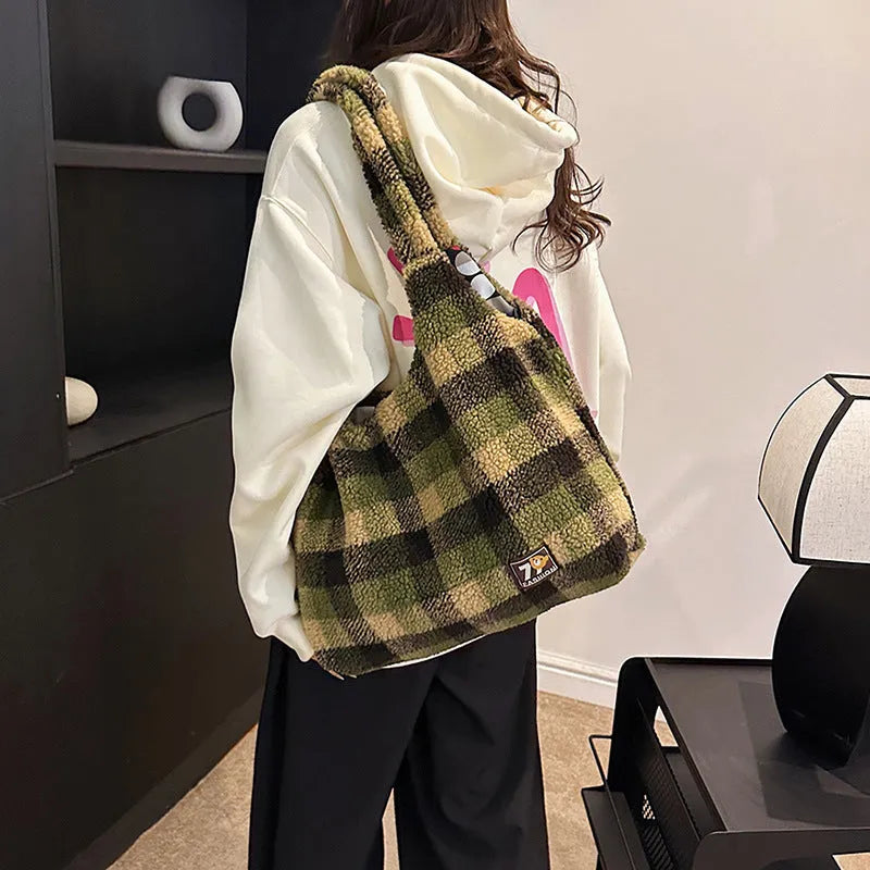 Women's plaid pattern crossbody tote bag showing soft plush material and horizontal square shape with crossbody strap.