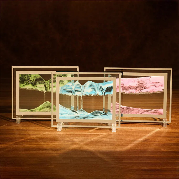 Glass quicksand painting ornament with geometric shape showing landscape sand art in black and white green colours.