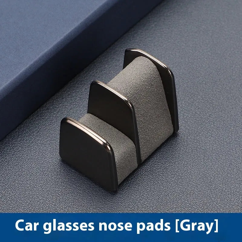 Zinc alloy and leather sunglasses clip for car dashboard storage in four colour options.