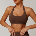 Women's black halter neck nylon sports bra for yoga and workouts on a mannequin.