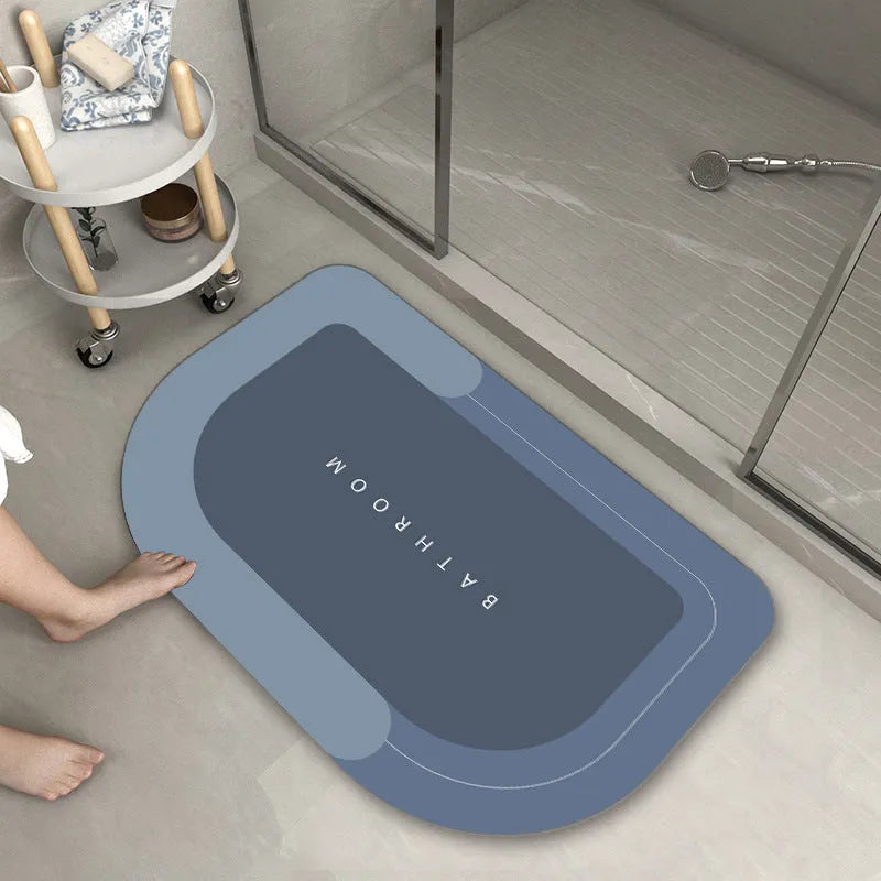 Blue oval blended fabric bathroom floor mat on a tiled floor