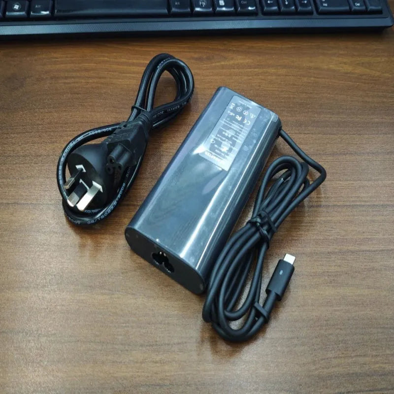 Black 65W Type-C laptop power adapter with multiple international power plugs