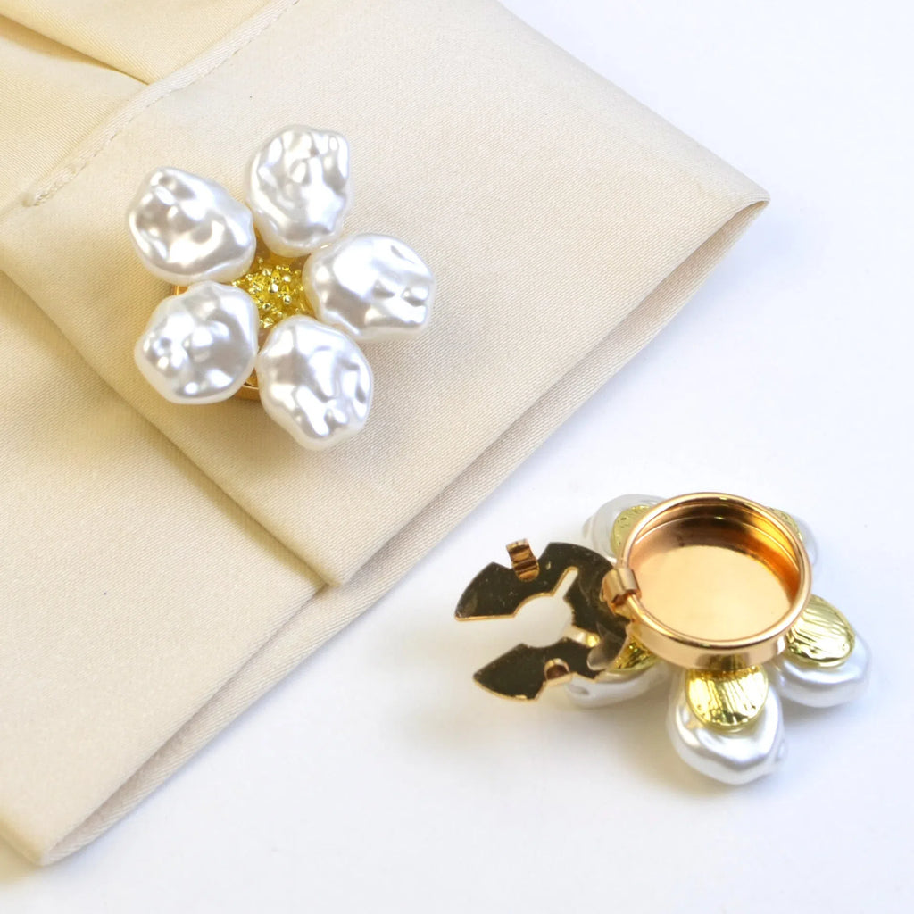 White alloy pearl rhinestone cufflink with electroplated finish and inlaid diamond setting on solid background