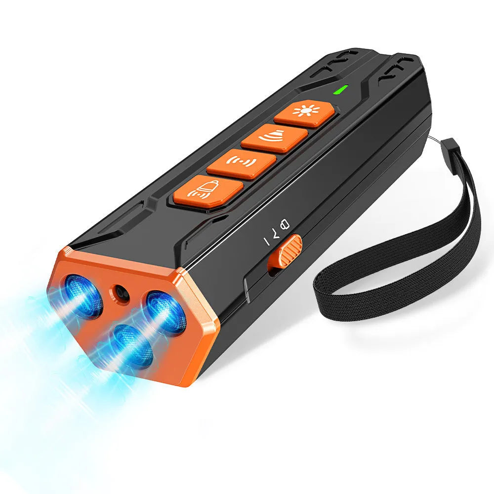 Grey and orange coloured three-head ultrasonic dog trainer with remote control on a table.