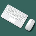 Pink wireless Bluetooth keyboard and mute mouse with USB charging cable on a desk