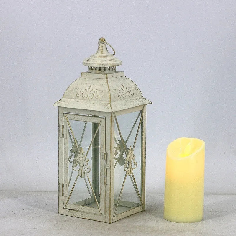 Black wrought iron floor-standing storm lantern with tempered glass panels for outdoor candle lighting
