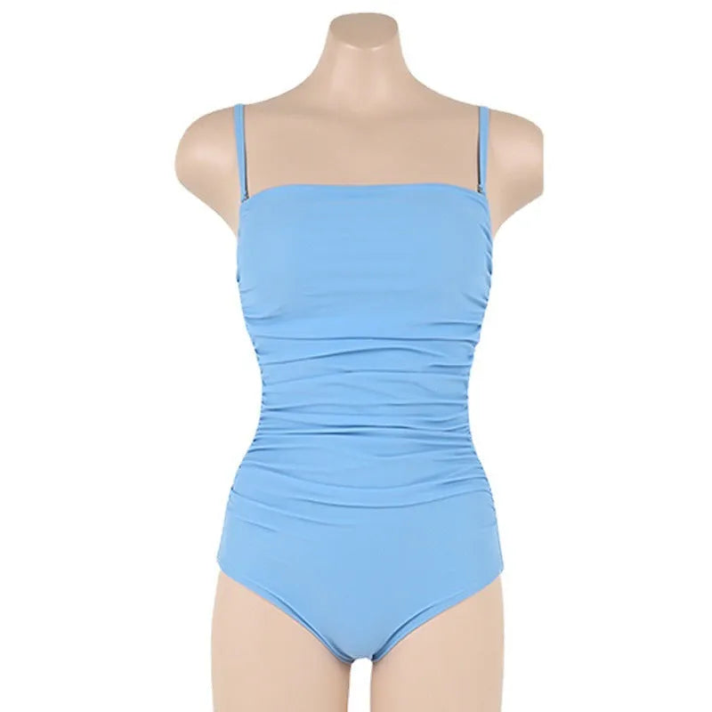 Sling style one-piece swimsuit with belly pleating in a solid colour.