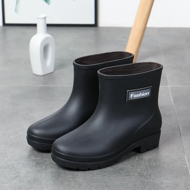 Women's mid-calf PVC rain boot in black, shown with a low heel and optional wool lining.
