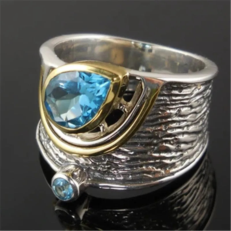Close-up of a women's blue zircon alloy ring with Chinese style drop shape design and rhinestone inlay.