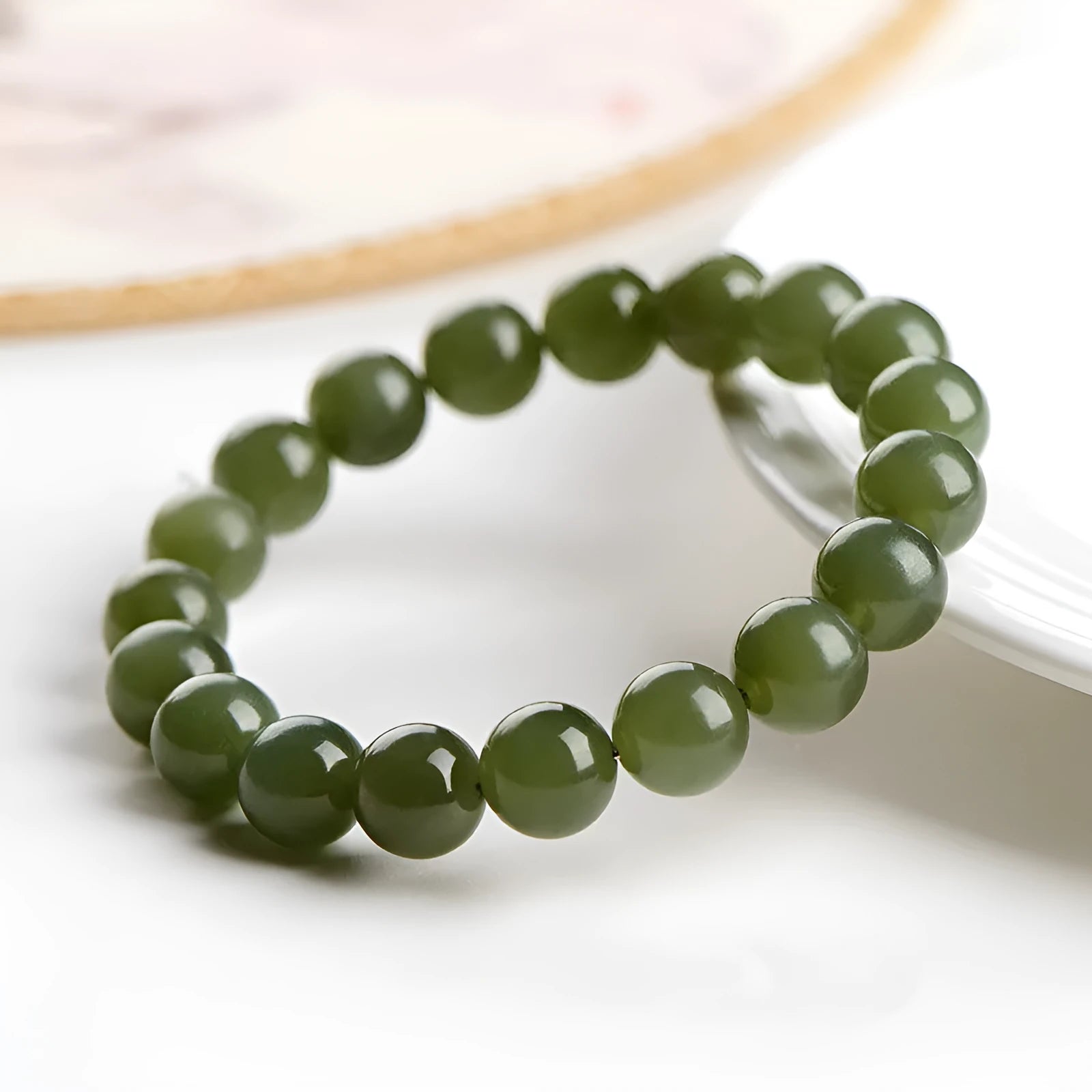 Polished Hetian jade beaded bracelet in ice-like clear water colour on a wrist.