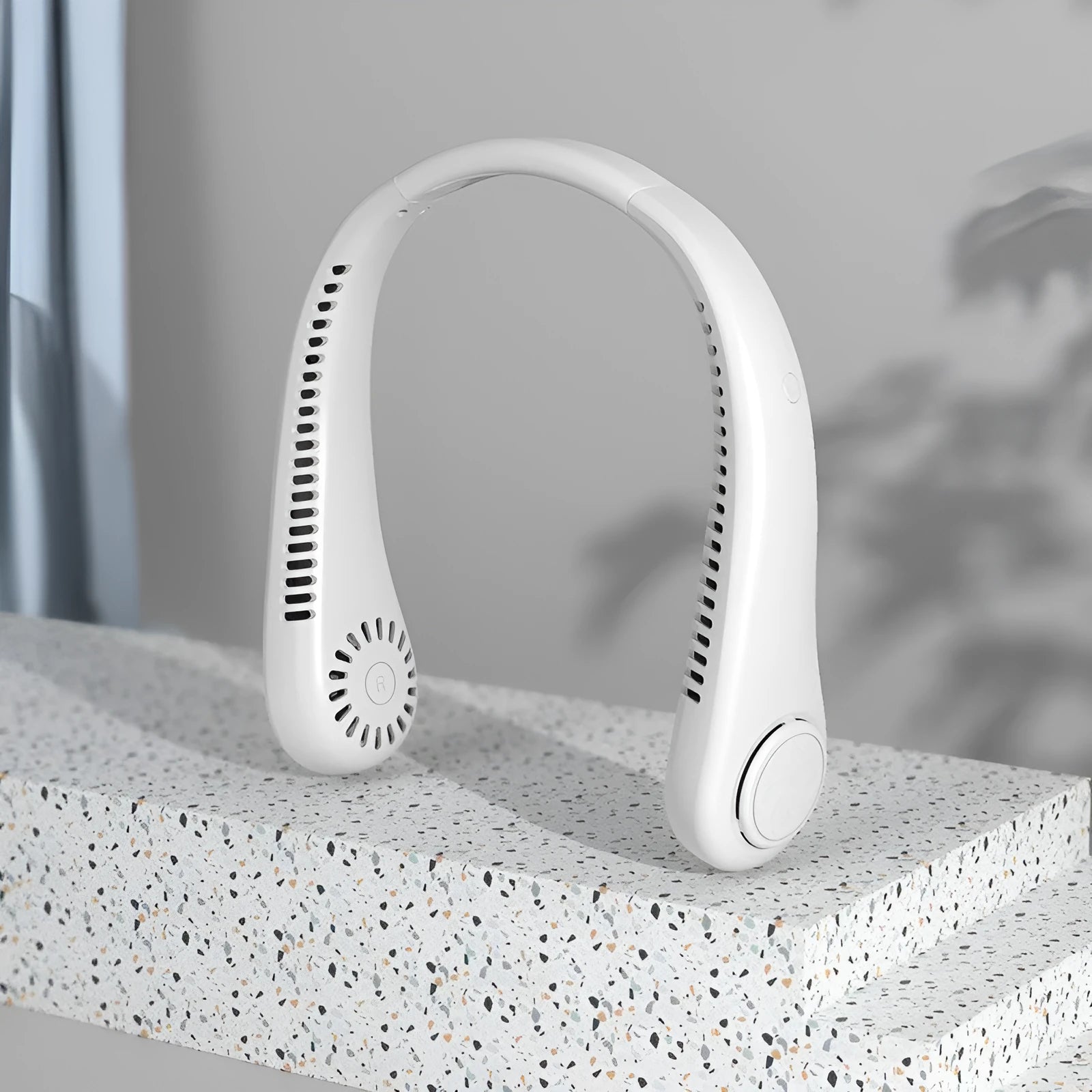 White USB rechargeable bladeless neck fan with adjustable speed settings.