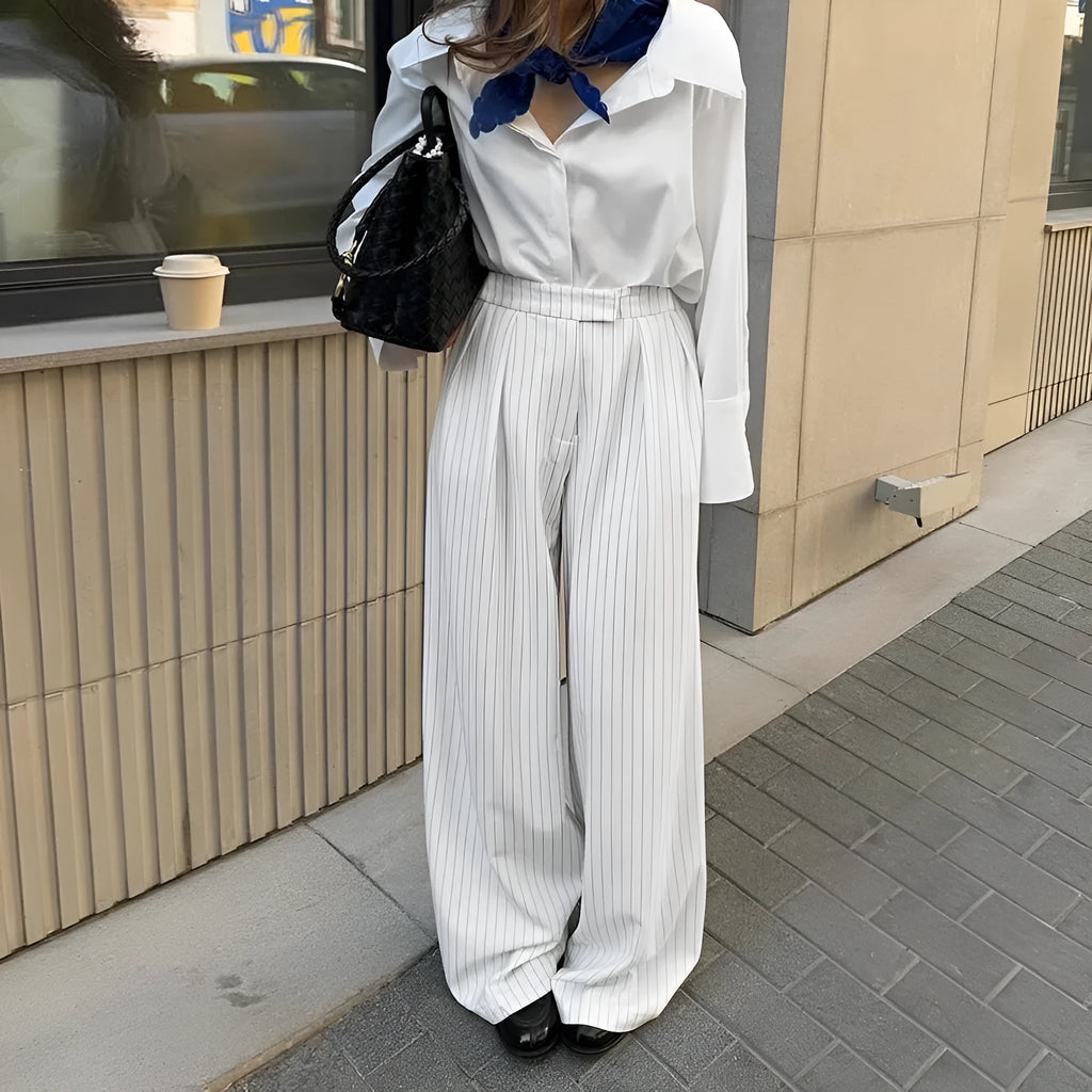White striped wide-leg trousers with front zipper detail and loose casual fit