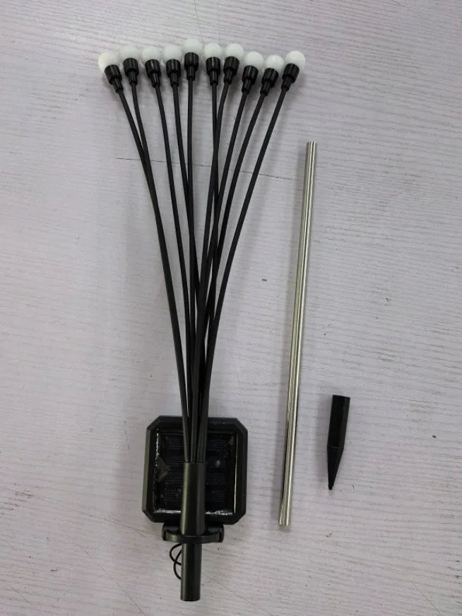Solar-powered LED ground spike garden light with multiple heads and stainless steel soil plug.
