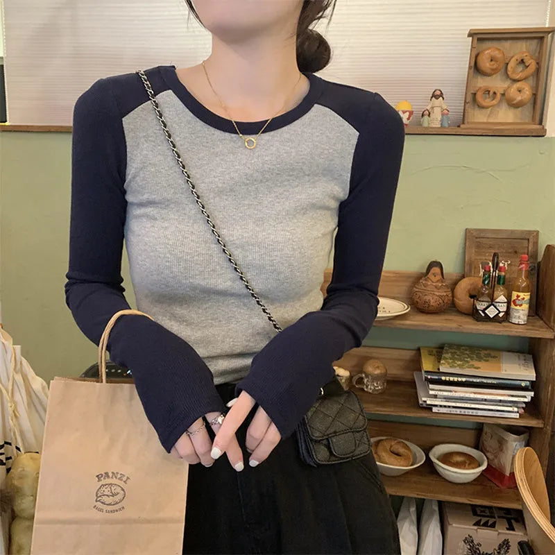 Women's dark blue viscose top with princess sleeves and embroidery detail on a hanger.