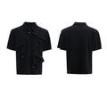 Men's black polo shirt with a deconstructed collar and geometric pattern, loose fit.