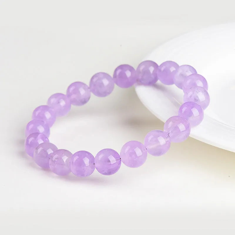Lavender round amethyst bead bracelet with water ripple design on a cream body and transparent lavender beads.