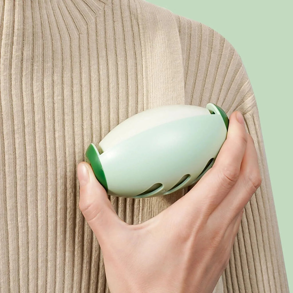 Green and white reusable gel lint roller ball for portable pet hair and lint removal.