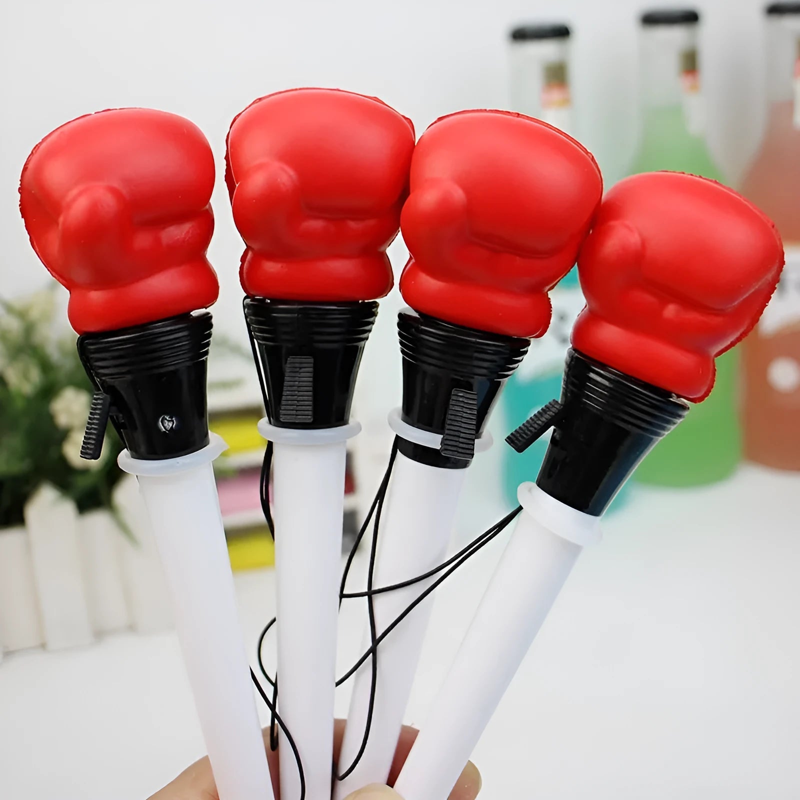 Four Creative Pressure Relief Boxing Press Ejection Pens with plug-in sleeves and black ink refills.