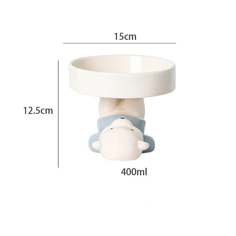 Raised ceramic cat food bowl in animal design, showing elevated height and wide bowl.