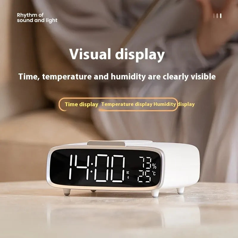 White wireless charger Bluetooth speaker alarm clock with LED night light on bedside table