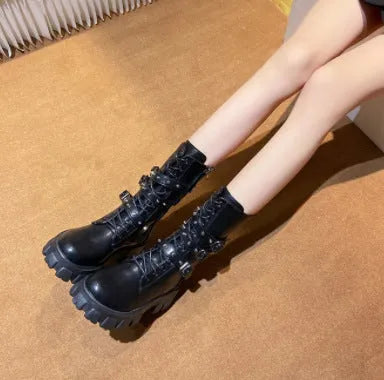 Women's black mid-calf boots with a metal buckle strap and side zipper, made of artificial PU leather.