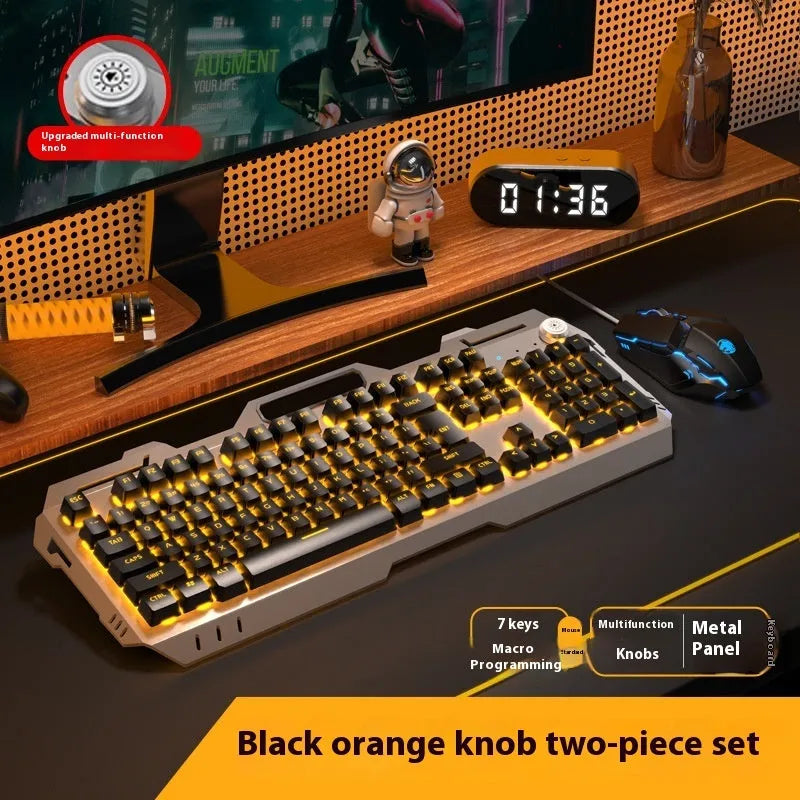 Aluminium gaming keyboard with volume knob, shown in metal grey with RGB lighting alongside optional macro mouse and headset.