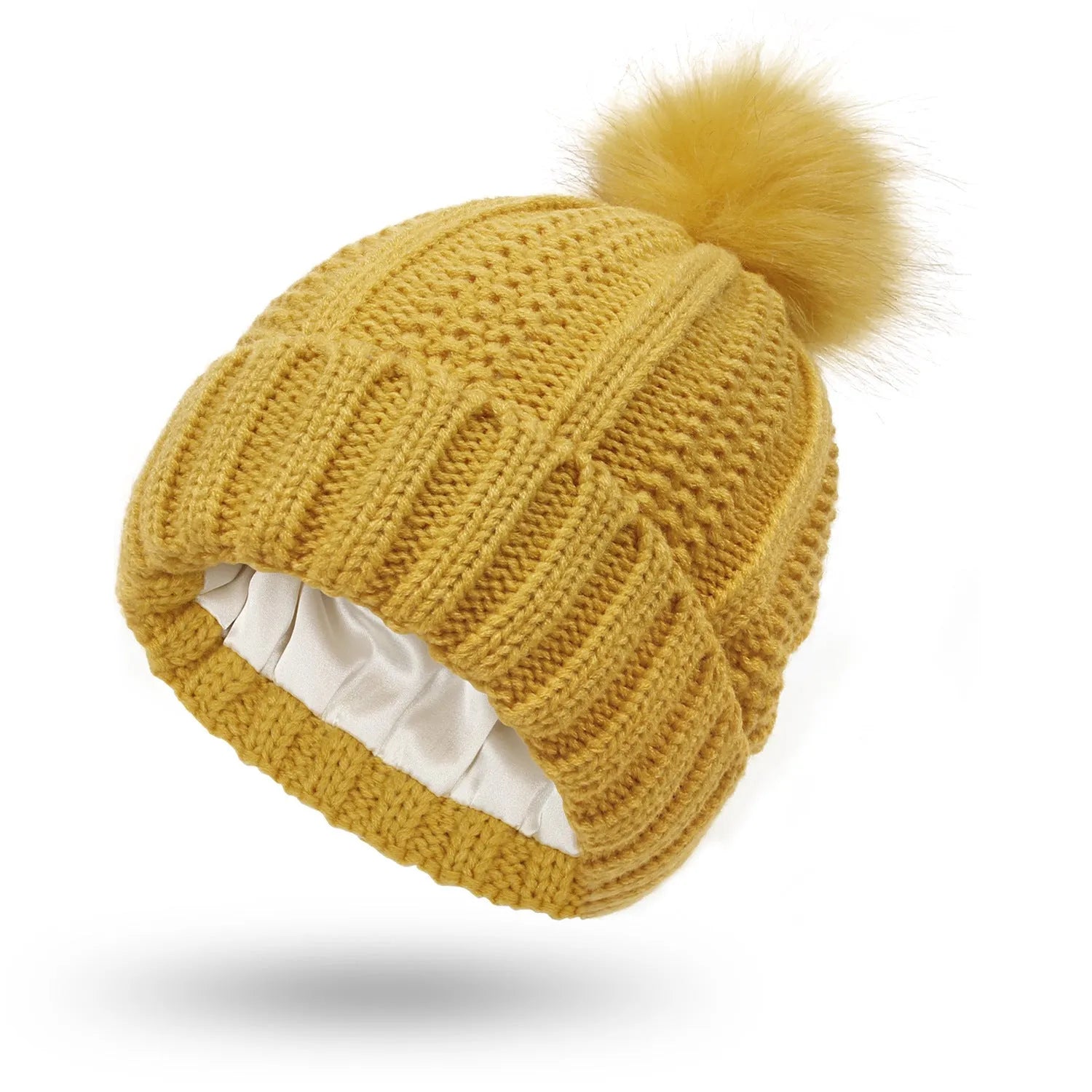 Woman wearing a light grey wool beanie with a faux fur pom pom and satin lining.