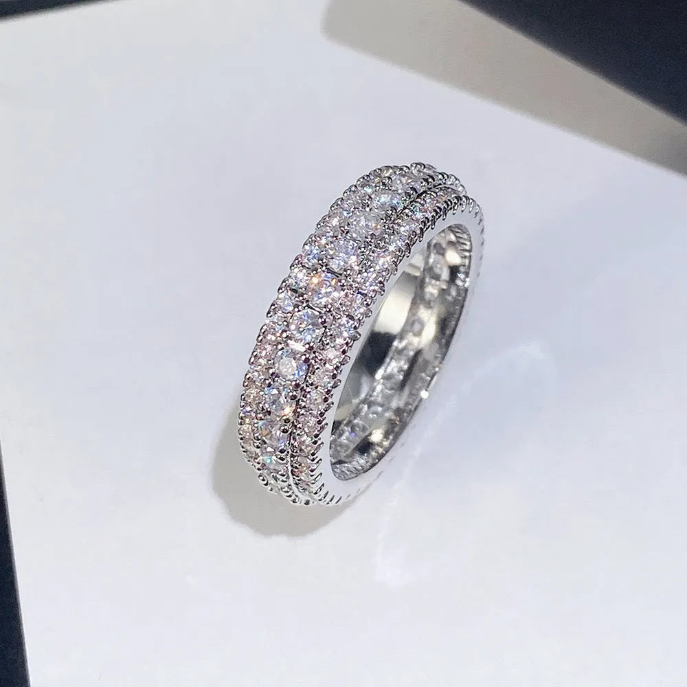 Geometric triangle design engagement ring with zircon stone inlay, shown in different metal plating finishes.