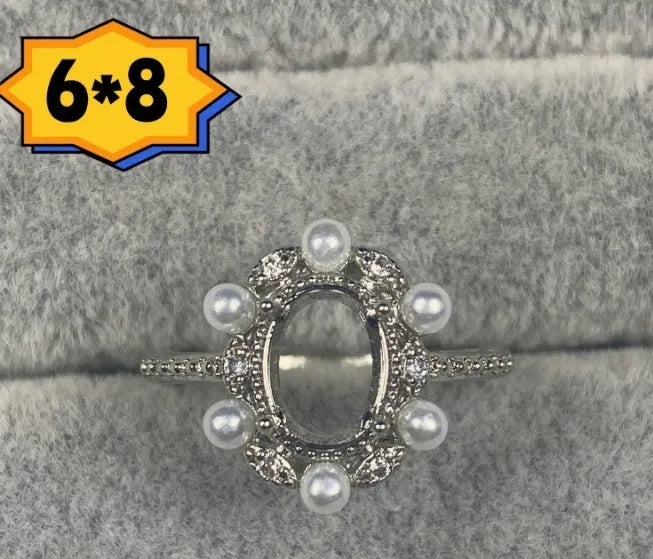 Oval denier ring with five-pointed star ornamentation and 6x8 mm main stone