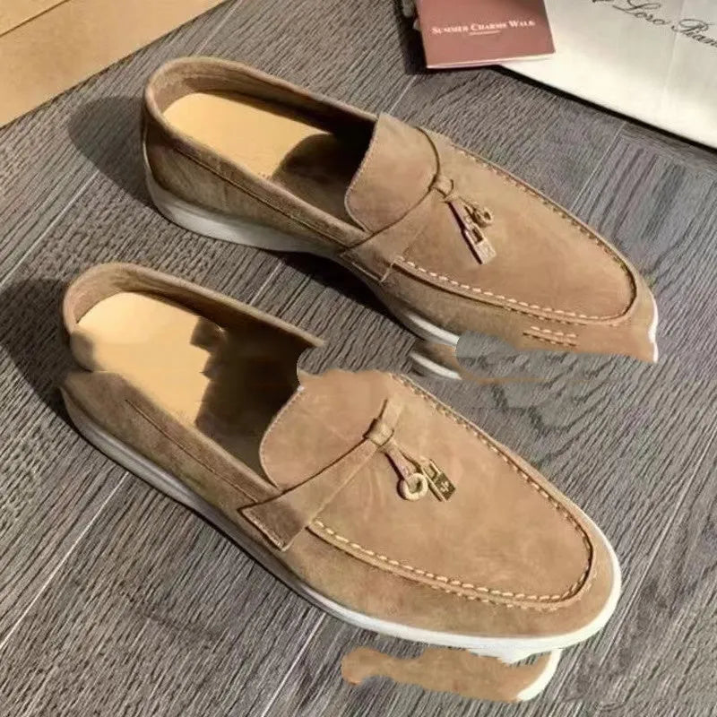 Unisex high-top slip-on loafers with a round toe cap and rubber sole on a neutral background.