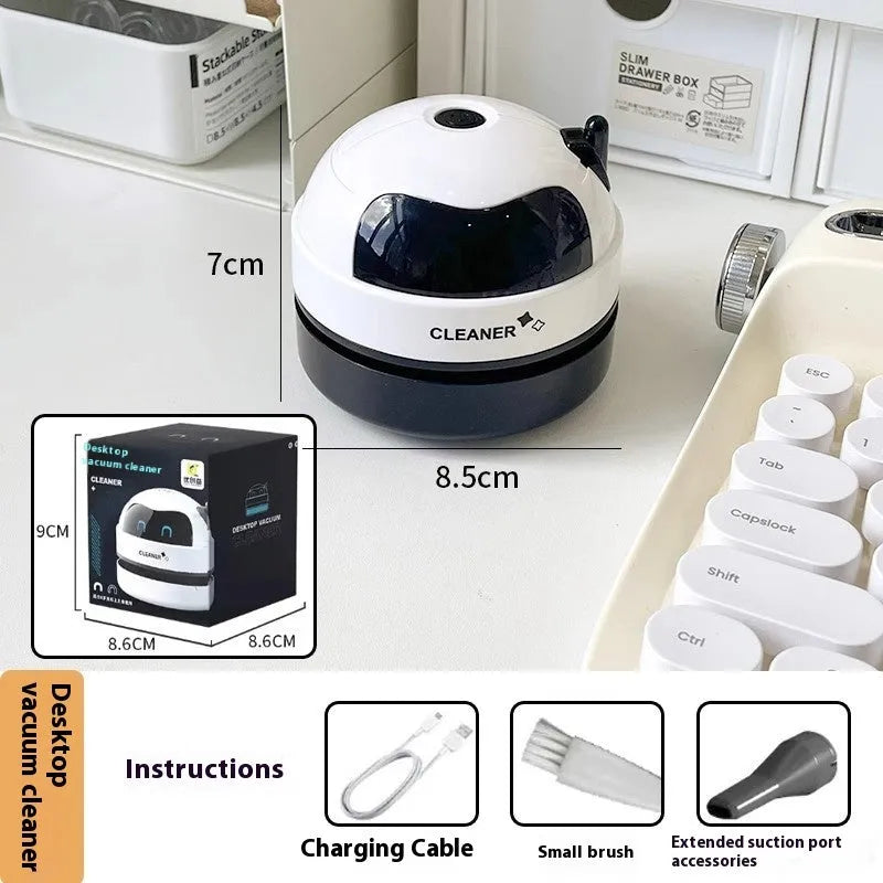 USB handheld desktop vacuum cleaner in blue rocket design on a wooden desk