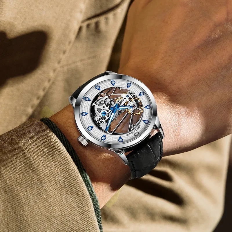 Men's silver case mechanical watch with black leather strap, white face, blue hands, and business styling