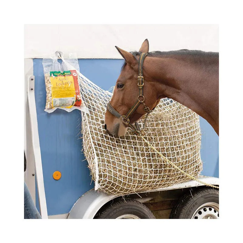 Woven PE rope mesh horse feeding bag hanging with hay inside, black colour shown